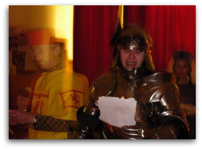 knight in armour greets lord and lady at  medieval banquet 